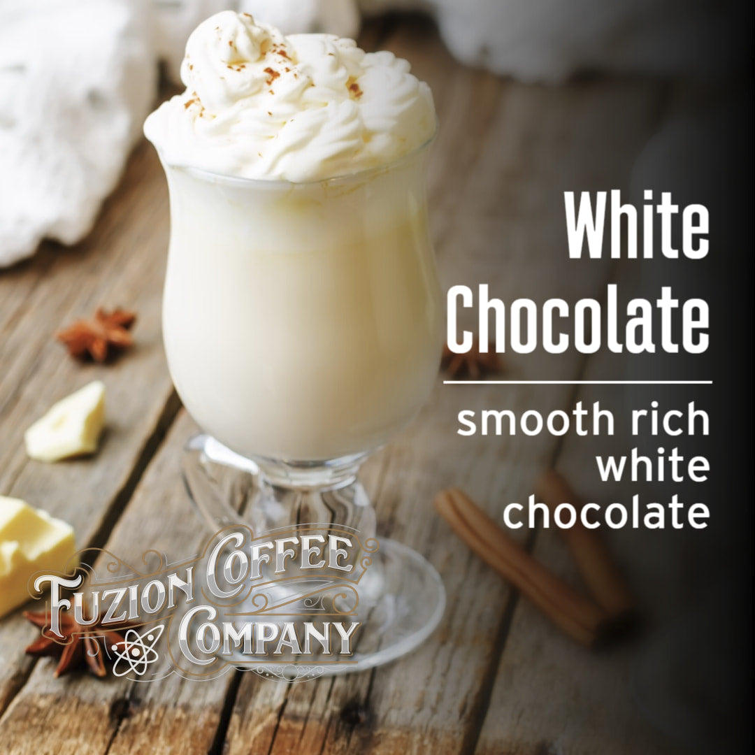 Glass of white chocolate drink with whipped cream on a wooden surface, featuring Fuzion Coffee Company branding.